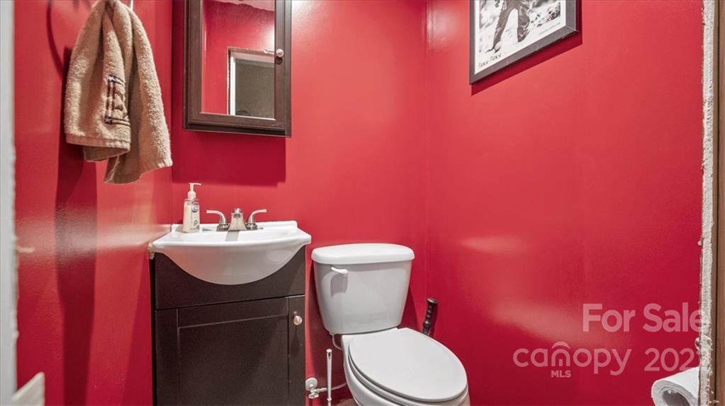 4410 Ansonville Road Marshville, NC 28103 - Photo 19 of 47 a bathroom with a toilet a sink and mirror