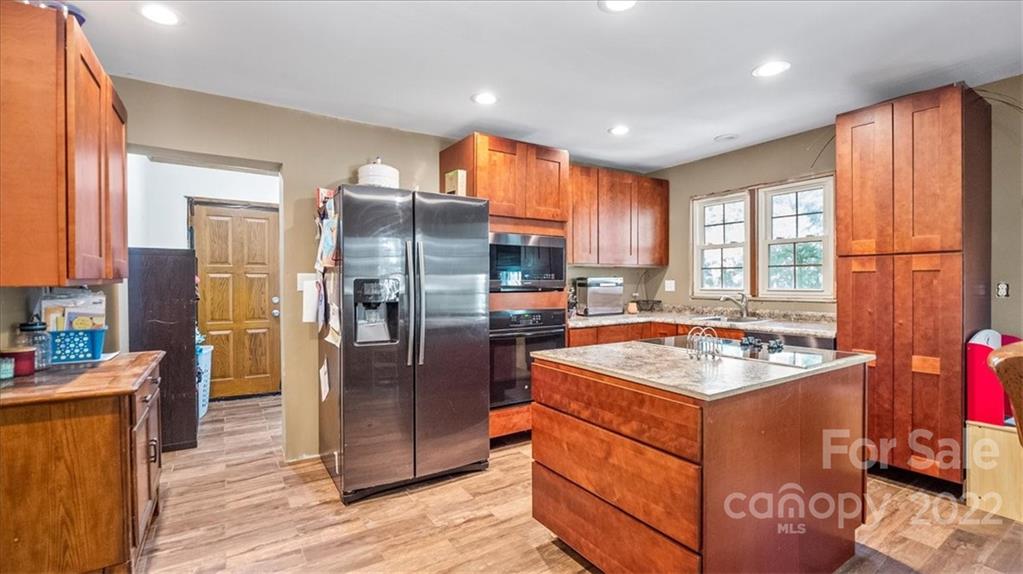 4410 Ansonville Road Marshville, NC 28103 - Photo 21 of 47 a kitchen with stainless steel appliances granite countertop a refrigerator a sink and a stove