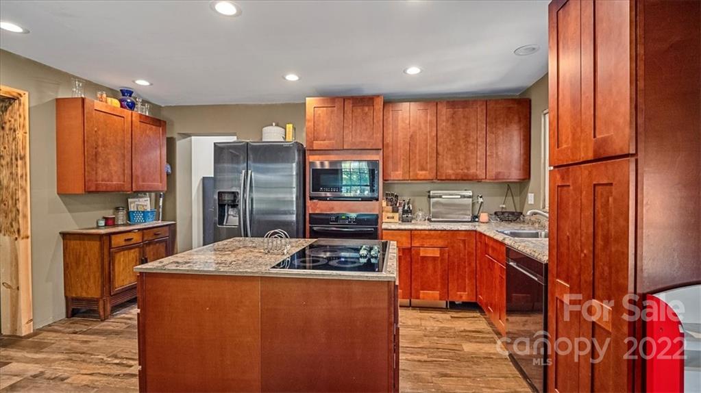 4410 Ansonville Road Marshville, NC 28103 - Photo 22 of 47 a kitchen with stainless steel appliances granite countertop a refrigerator and a stove top oven