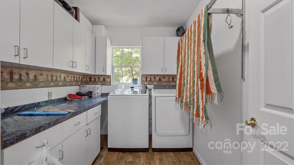 4410 Ansonville Road Marshville, NC 28103 - Photo 25 of 47 a view of a kitchen with fridge and wooden floor
