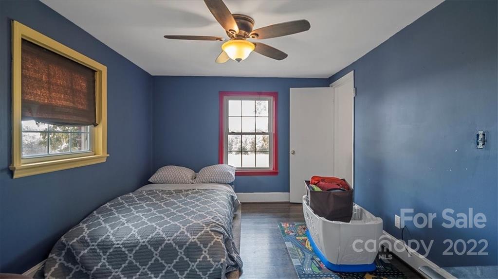 4410 Ansonville Road Marshville, NC 28103 - Photo 30 of 47 a bedroom with a bed and wooden floor
