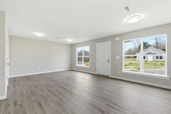 a view of a kitchen with a sink and a refrigerator