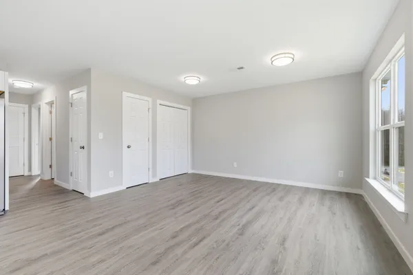 a kitchen with wooden floors and white appliances
