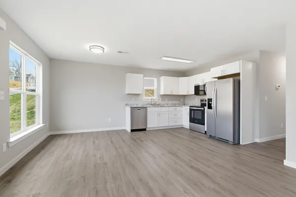 a kitchen with stainless steel appliances and wooden cabinets