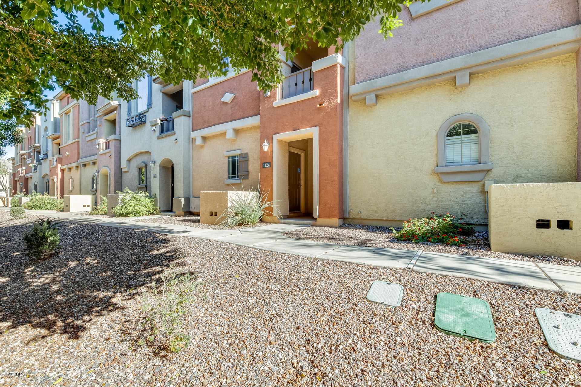 2401 East Rio Salado Parkway, Unit 1124 Tempe, AZ 85288 - Photo 7 of 32 a front view of a house with a yard