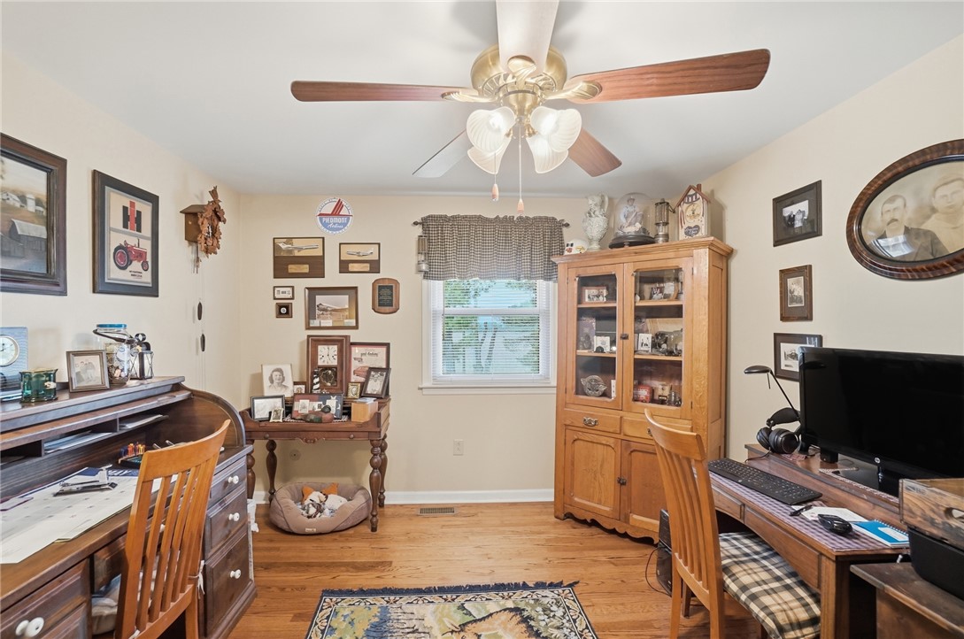 4170 Johnson Road Springfield, OH 45502 - Photo 47 of 54 Well-lit room featuring rich hardwood flooring and classic furnishings, ideal for a productive home office space.