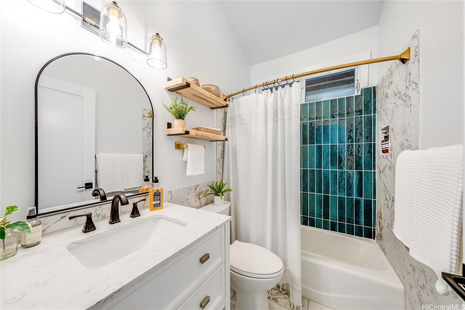 817 Ekoa Place Honolulu, HI 96821 - Photo 17 of 25 a bathroom with a sink a toilet and a mirror