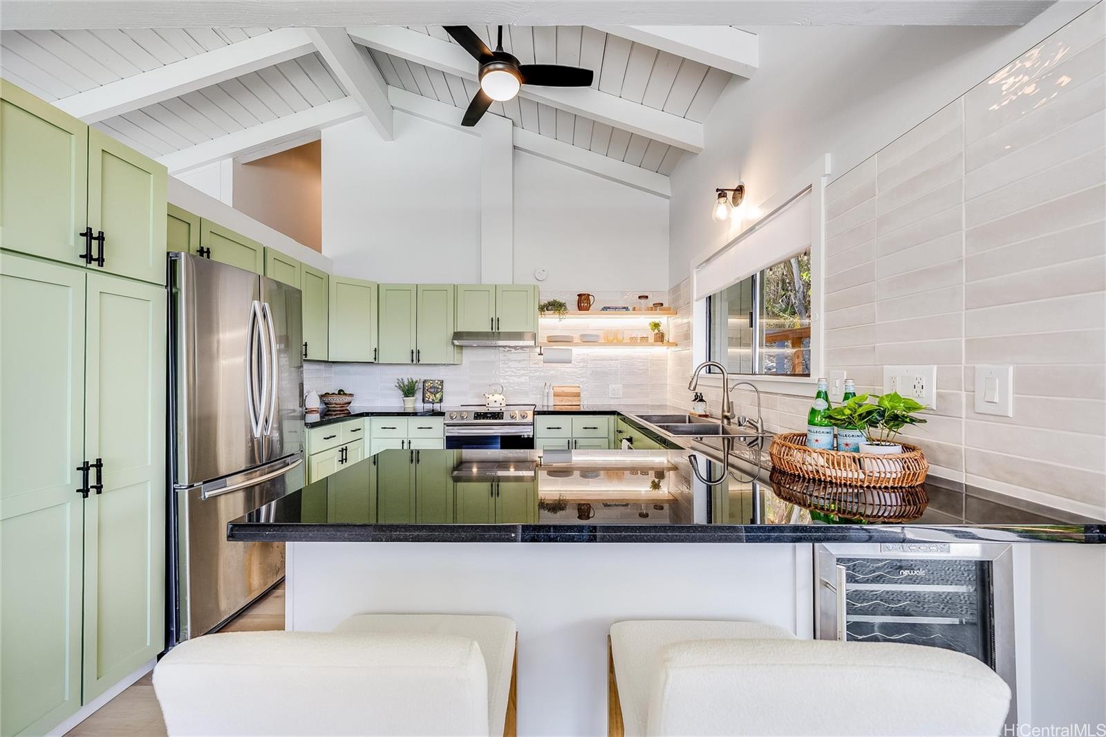 817 Ekoa Place Honolulu, HI 96821 - Photo 10 of 25 a kitchen with stainless steel appliances a white table chairs and a refrigerator