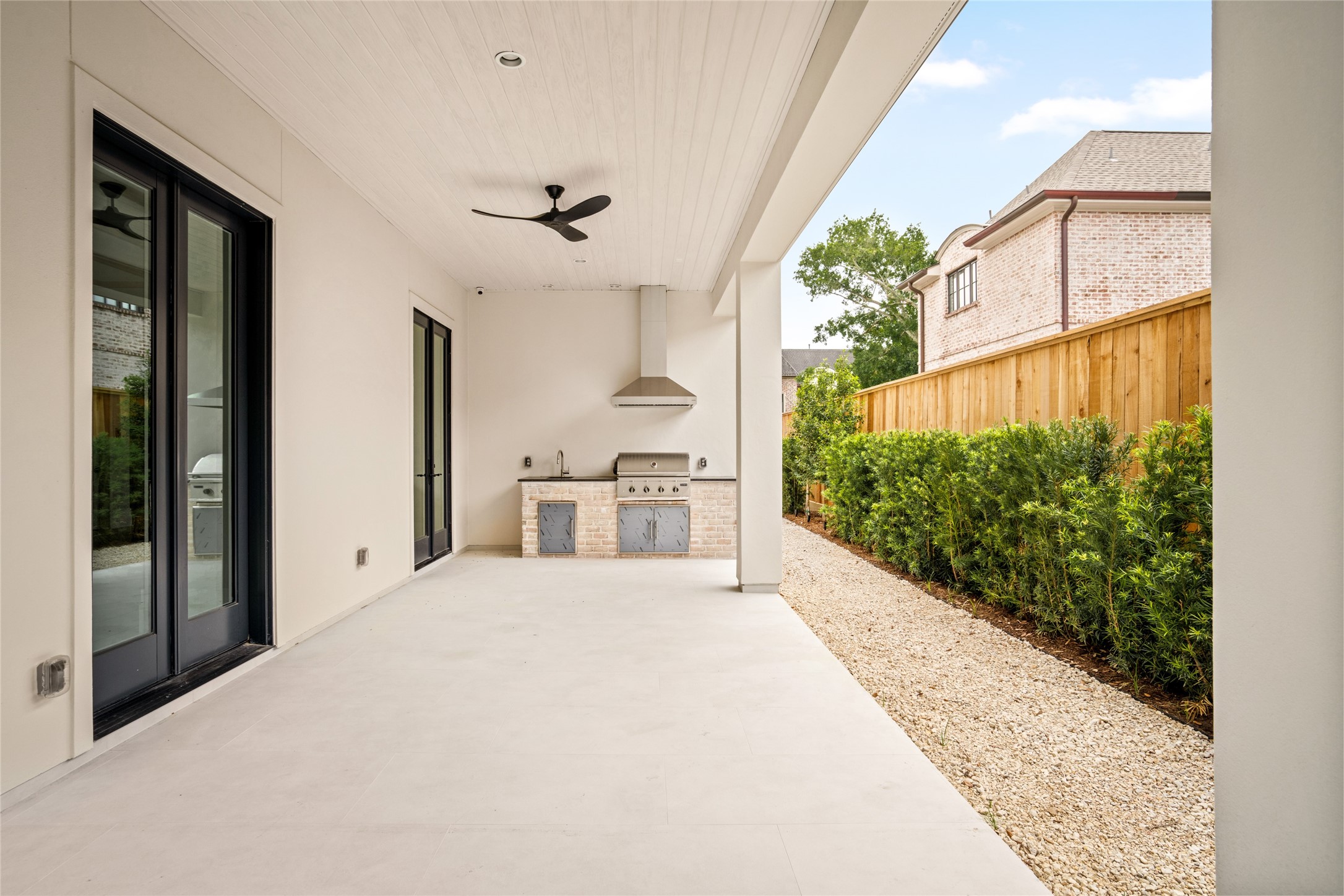 4006 Overbrook Lane Houston, TX 77027 - Photo 45 of 50 Expansive covered patio featuring a built-in outdoor kitchen and seamless indoor-outdoor flow.