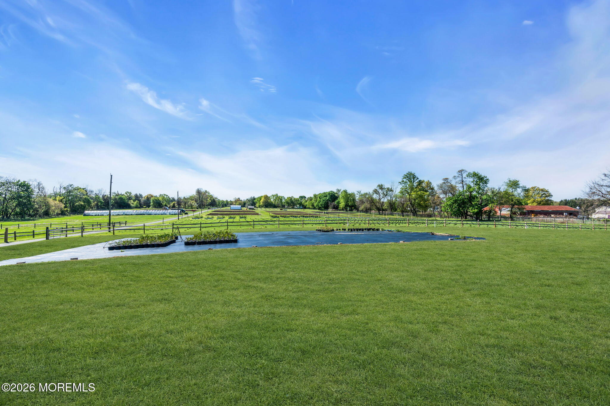 393 County Road 537 Colts Neck, NJ 07722 - Photo 18 of 41 a view of a golf course with a lake