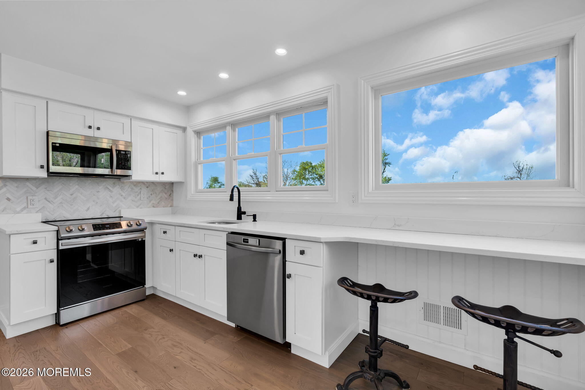 393 County Road 537 Colts Neck, NJ 07722 - Photo 10 of 41 a kitchen with stainless steel appliances a stove a sink and a microwave