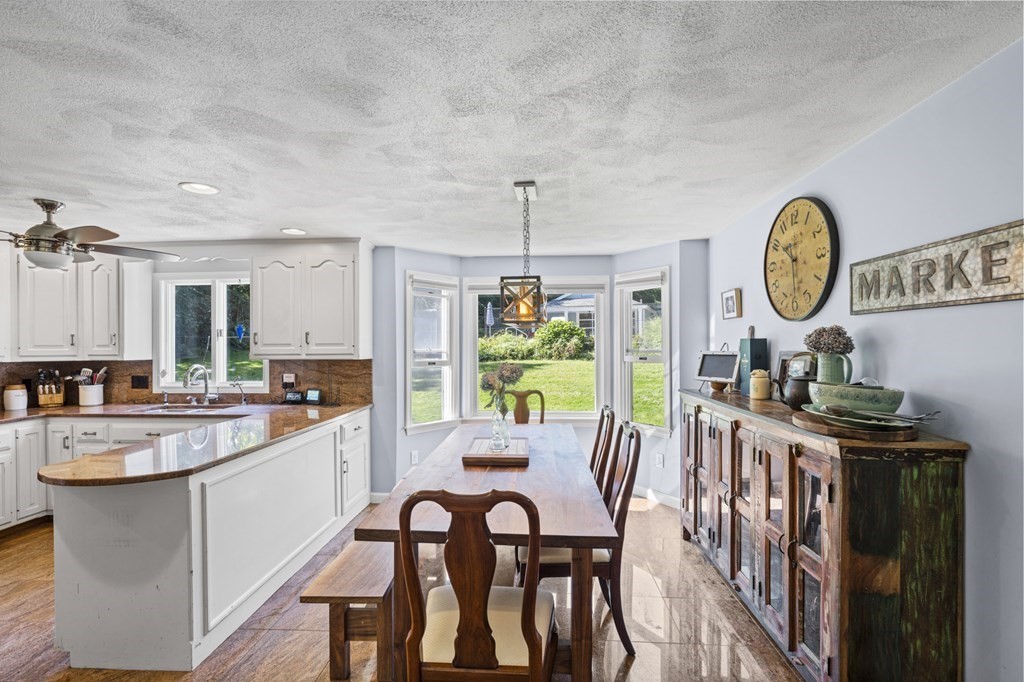 104 Burnt Swamp Road Cumberland, RI 02864 - Photo 11 of 32 a large kitchen with a table and chairs