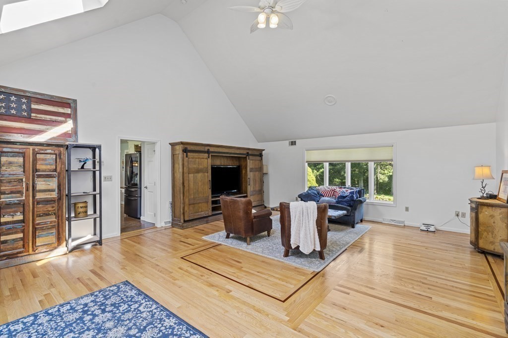 104 Burnt Swamp Road Cumberland, RI 02864 - Photo 14 of 32 a living room with furniture a fireplace and a table