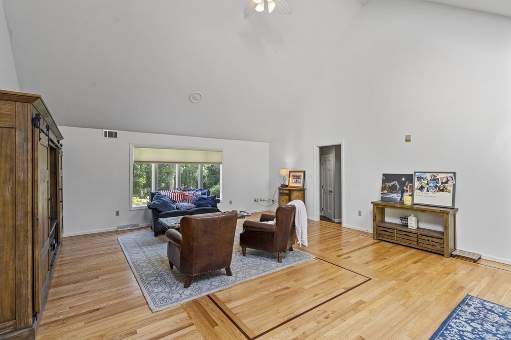 104 Burnt Swamp Road Cumberland, RI 02864 - Photo 15 of 32 a living room with furniture a large window and wooden floor