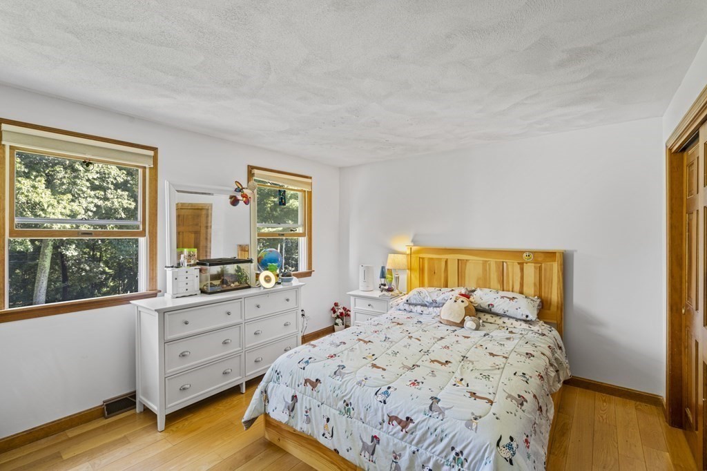 104 Burnt Swamp Road Cumberland, RI 02864 - Photo 17 of 32 a bedroom with a bed and a window