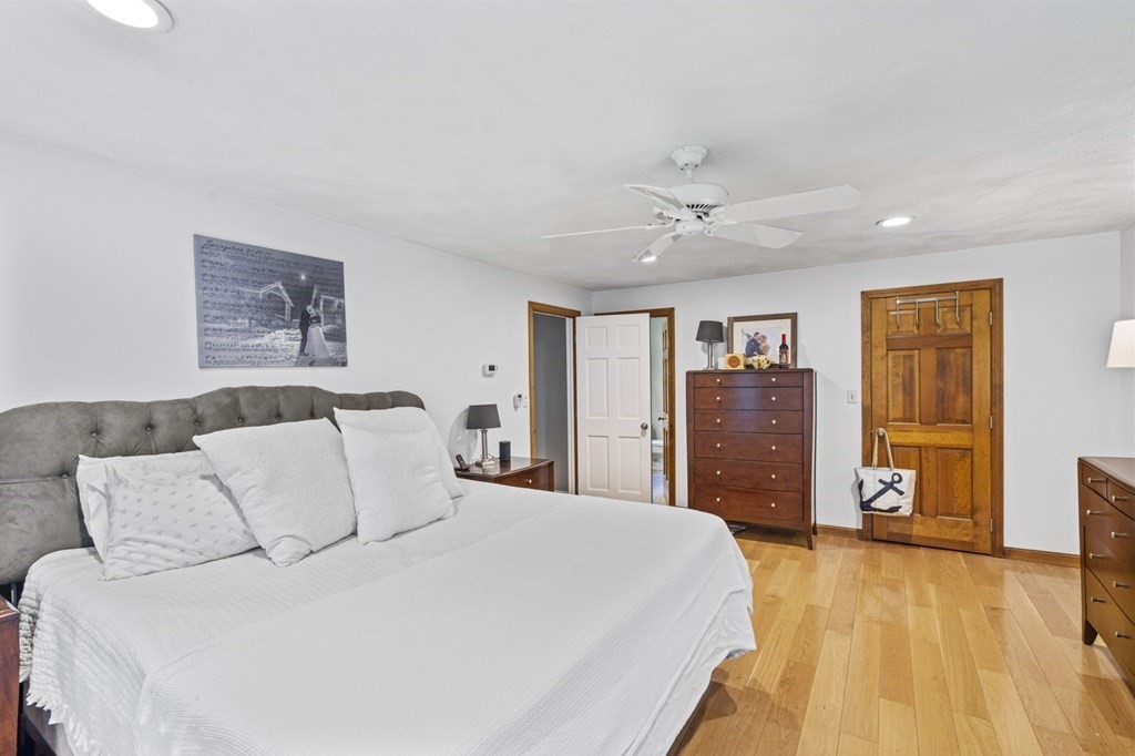 104 Burnt Swamp Road Cumberland, RI 02864 - Photo 19 of 32 a spacious bedroom with a bed and a flat screen tv