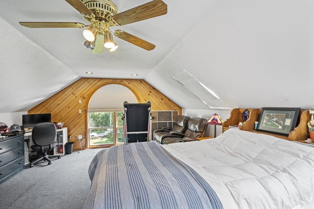 104 Burnt Swamp Road Cumberland, RI 02864 - Photo 21 of 32 a bedroom with a bed and a chandelier