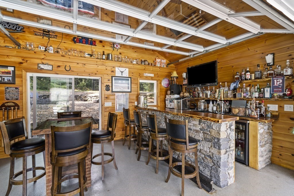 104 Burnt Swamp Road Cumberland, RI 02864 - Photo 29 of 32 a dining room with furniture and a flat screen tv