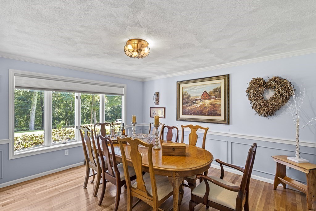 104 Burnt Swamp Road Cumberland, RI 02864 - Photo 3 of 32 a view of a dining room with furniture a chandelier and wooden floor