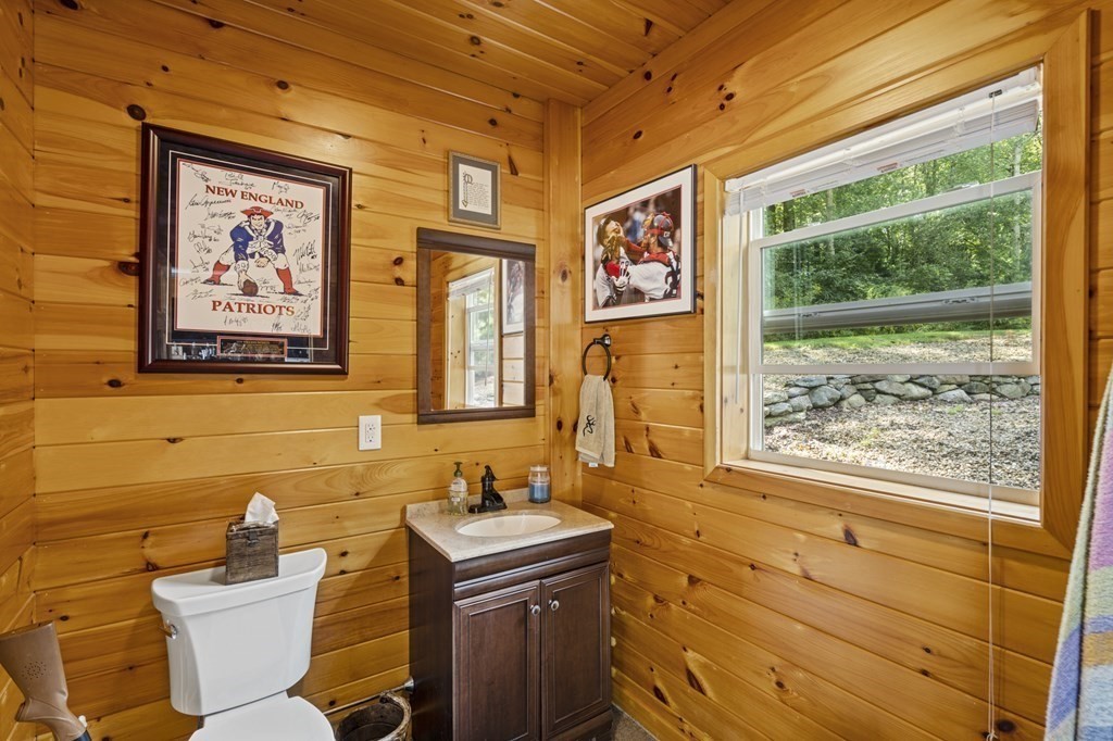 104 Burnt Swamp Road Cumberland, RI 02864 - Photo 32 of 32 a bathroom with a sink and a mirror