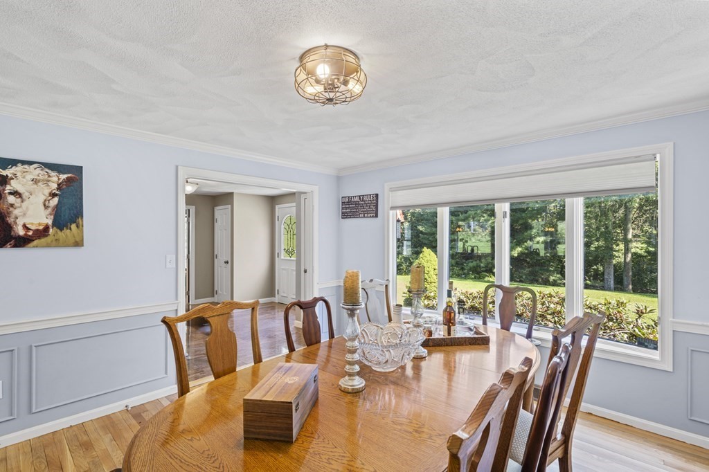 104 Burnt Swamp Road Cumberland, RI 02864 - Photo 4 of 32 a view of a dining room with furniture a chandelier and wooden floor