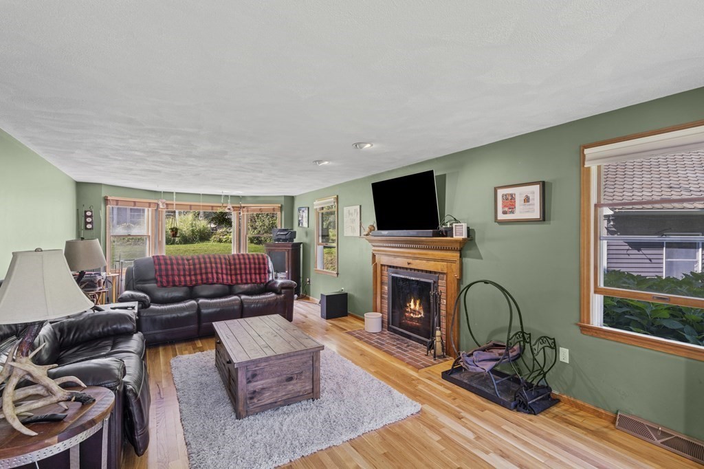 104 Burnt Swamp Road Cumberland, RI 02864 - Photo 5 of 32 a living room with furniture and a fireplace