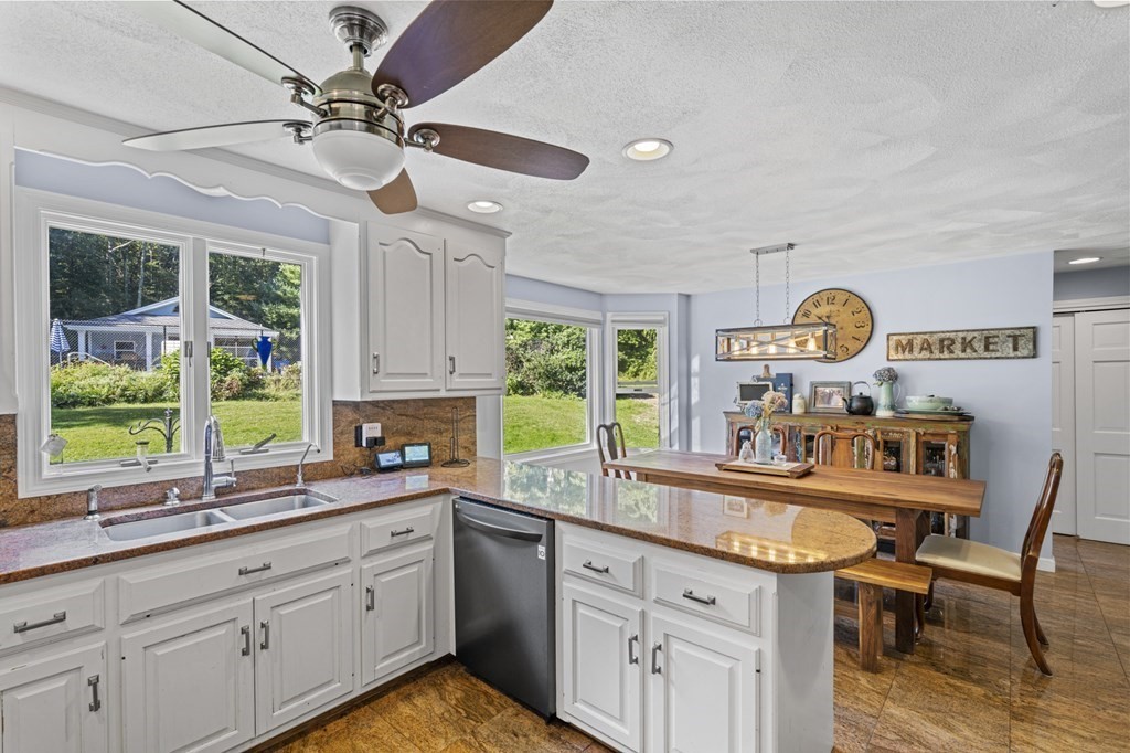 104 Burnt Swamp Road Cumberland, RI 02864 - Photo 10 of 32 a kitchen with granite countertop a sink a center island cabinets and stainless steel appliances
