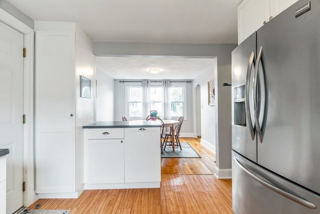 22 Sumner Street Dedham, MA 02026 - Photo 15 of 39 a kitchen with stainless steel appliances granite countertop a refrigerator sink and white cabinets