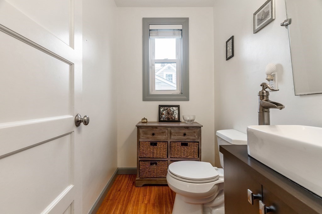 22 Sumner Street Dedham, MA 02026 - Photo 17 of 39 a bathroom with a toilet a sink and a bathtub