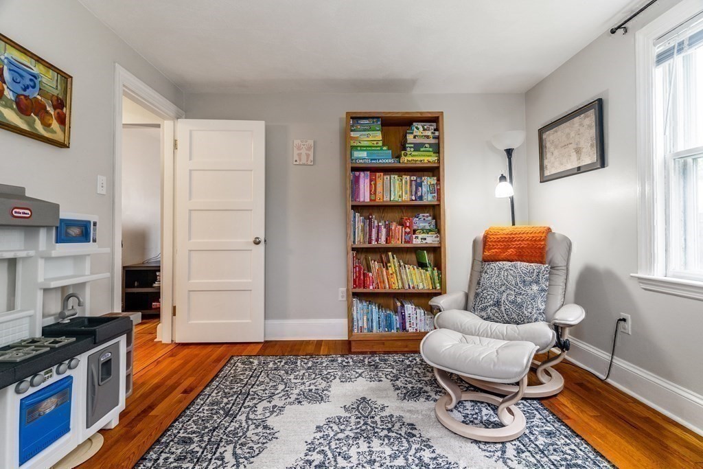 22 Sumner Street Dedham, MA 02026 - Photo 19 of 39 a living room with furniture and a book shelf