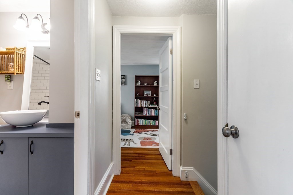 22 Sumner Street Dedham, MA 02026 - Photo 21 of 39 a view of a hallway with wooden shelves