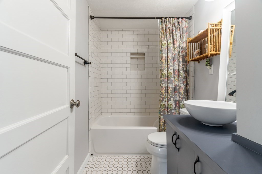 22 Sumner Street Dedham, MA 02026 - Photo 22 of 39 a bathroom with a toilet and a bathtub