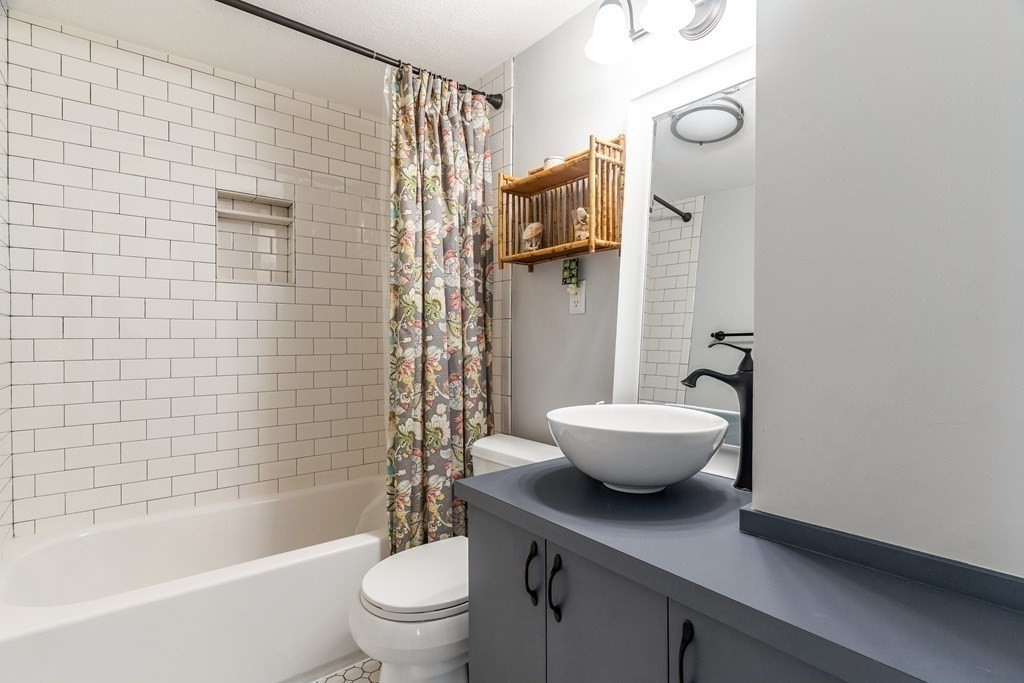 22 Sumner Street Dedham, MA 02026 - Photo 23 of 39 a bathroom with a sink a toilet and shower