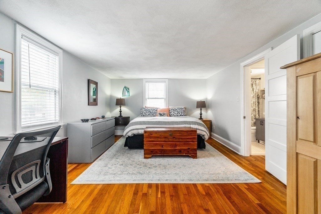 22 Sumner Street Dedham, MA 02026 - Photo 26 of 39 a bedroom with a bed and wooden floor