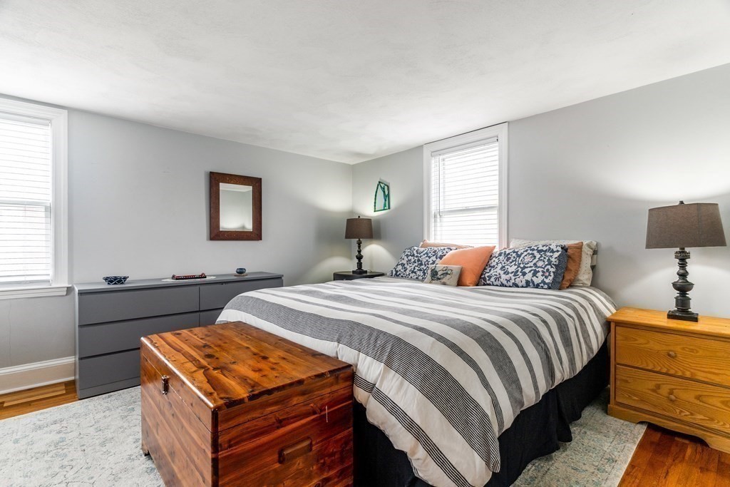 22 Sumner Street Dedham, MA 02026 - Photo 27 of 39 a bedroom with a bed and a night stand