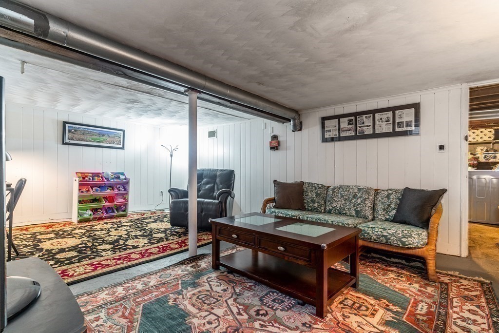22 Sumner Street Dedham, MA 02026 - Photo 33 of 39 a living room with furniture and a rug