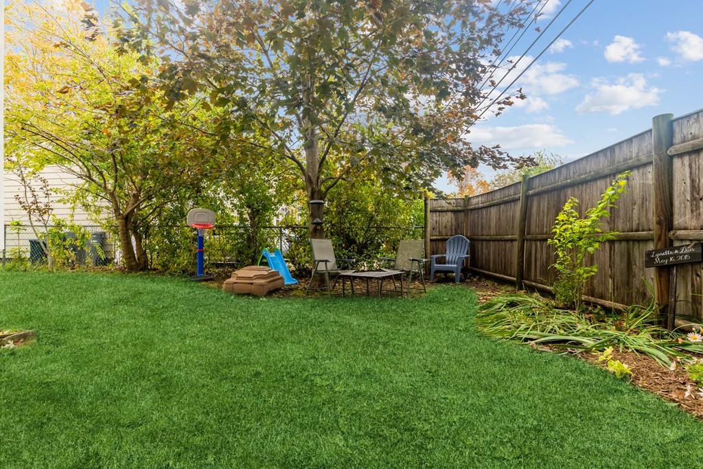 22 Sumner Street Dedham, MA 02026 - Photo 37 of 39 a view of a backyard with plants and large trees