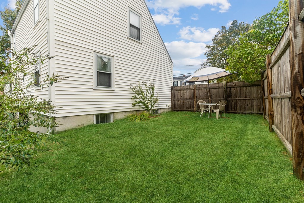 22 Sumner Street Dedham, MA 02026 - Photo 39 of 39 a backyard of a house with table and chairs