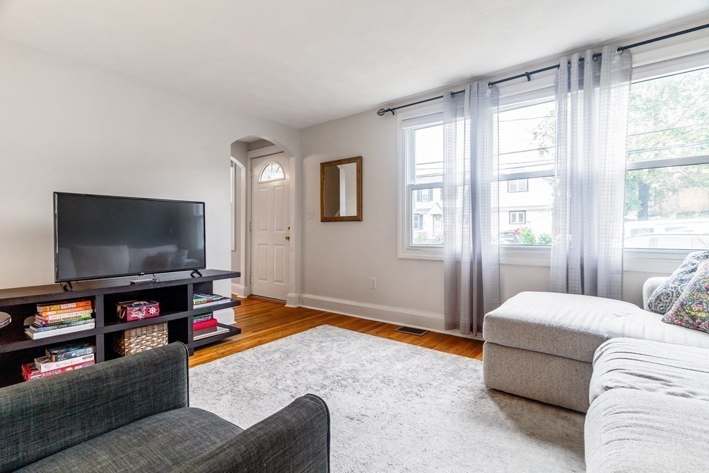 22 Sumner Street Dedham, MA 02026 - Photo 7 of 39 a living room with furniture and a flat screen tv