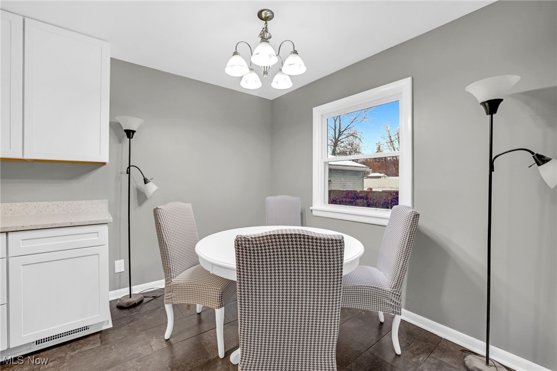 3930 Wadsworth Road Barberton, OH 44203 - Photo 7 of 30 Dining area with a chandelier and baseboards