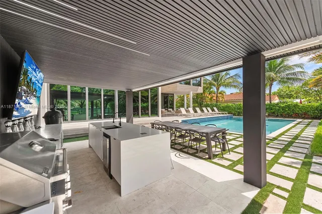 a living room with large windows and furniture