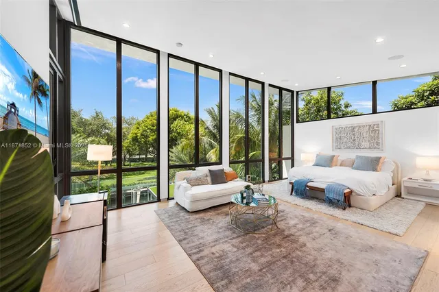 a spacious bedroom with a large bed and a large window