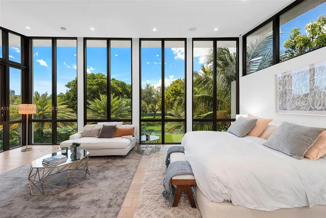 a bedroom with a large bed and a large window