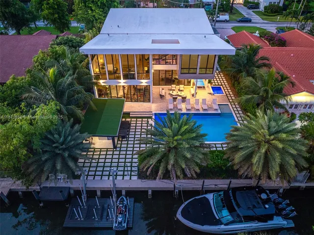 aerial view of a house with swimming pool and porch with furniture