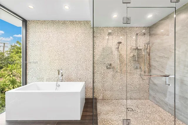 a bathroom with a bathtub and shower
