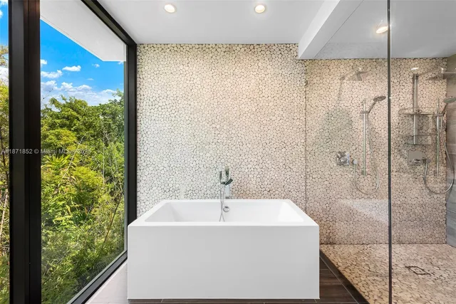 a bathroom with a bathtub and a shower