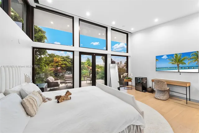 a bedroom with a large bed and a large window