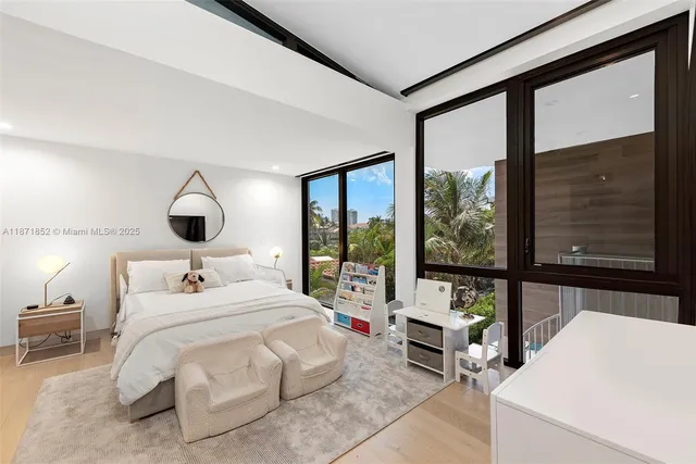 a bedroom with a bed and a large window