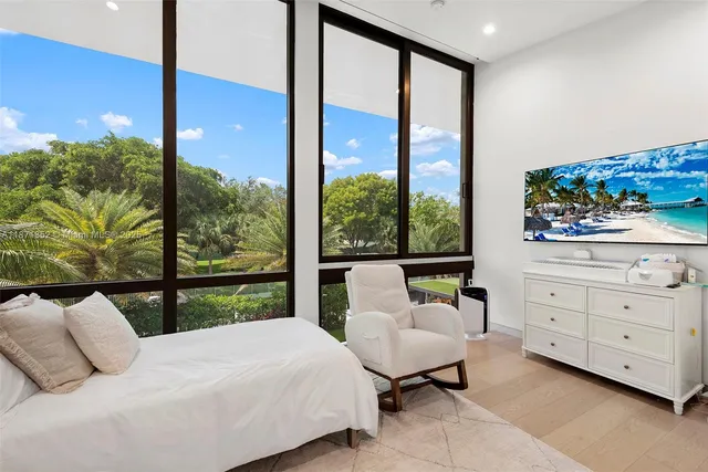 a bedroom with a bed and large window