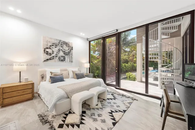 a bedroom with a large bed and a large window